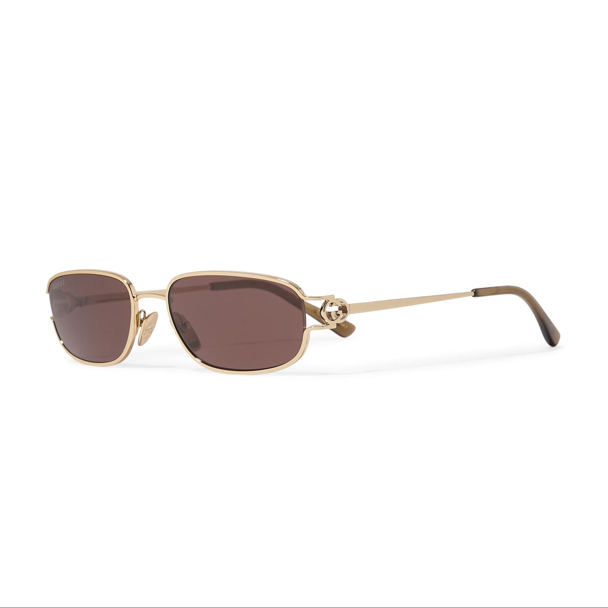 Gold-framed luxury sunglasses with brown tinted lenses and decorative temple accents