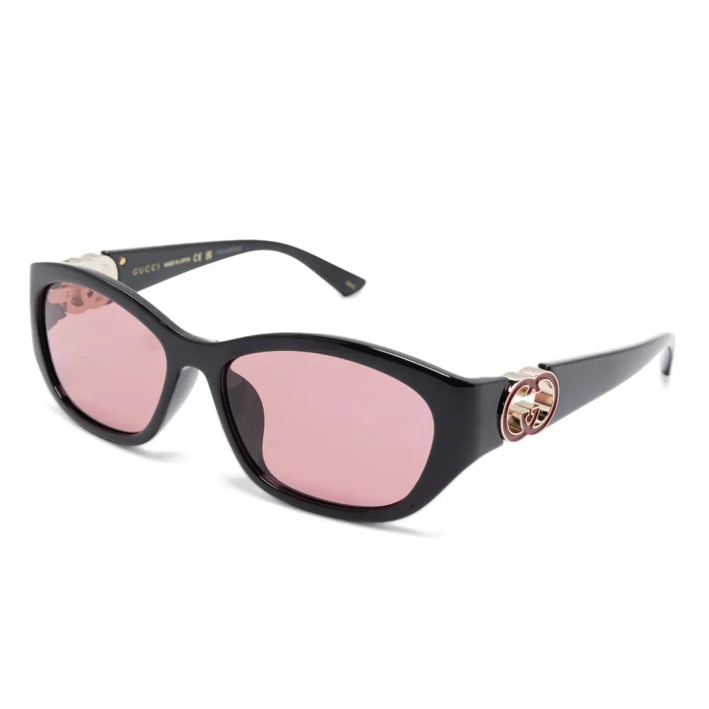 Black luxury sunglasses with pink tinted lenses and gold logo detail