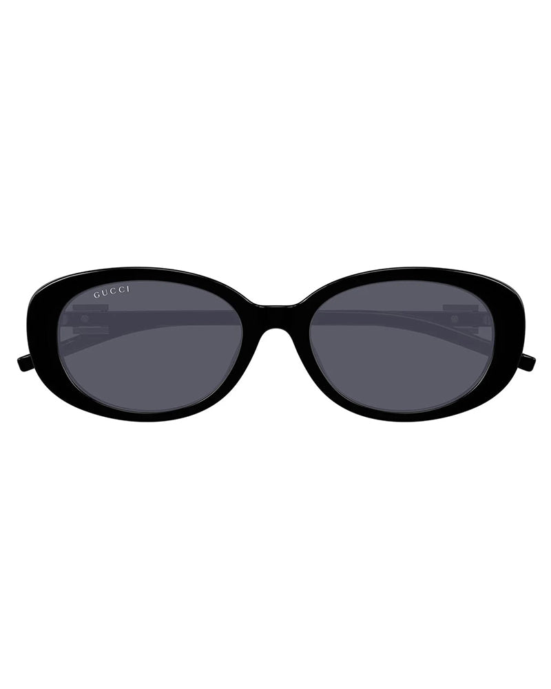 Gucci black oval-shaped luxury sunglasses with dark tinted lenses.