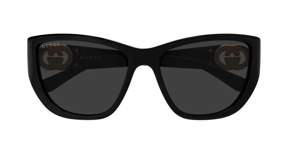 Black oversized Gucci luxury sunglasses with dark lenses and gold logo details.
