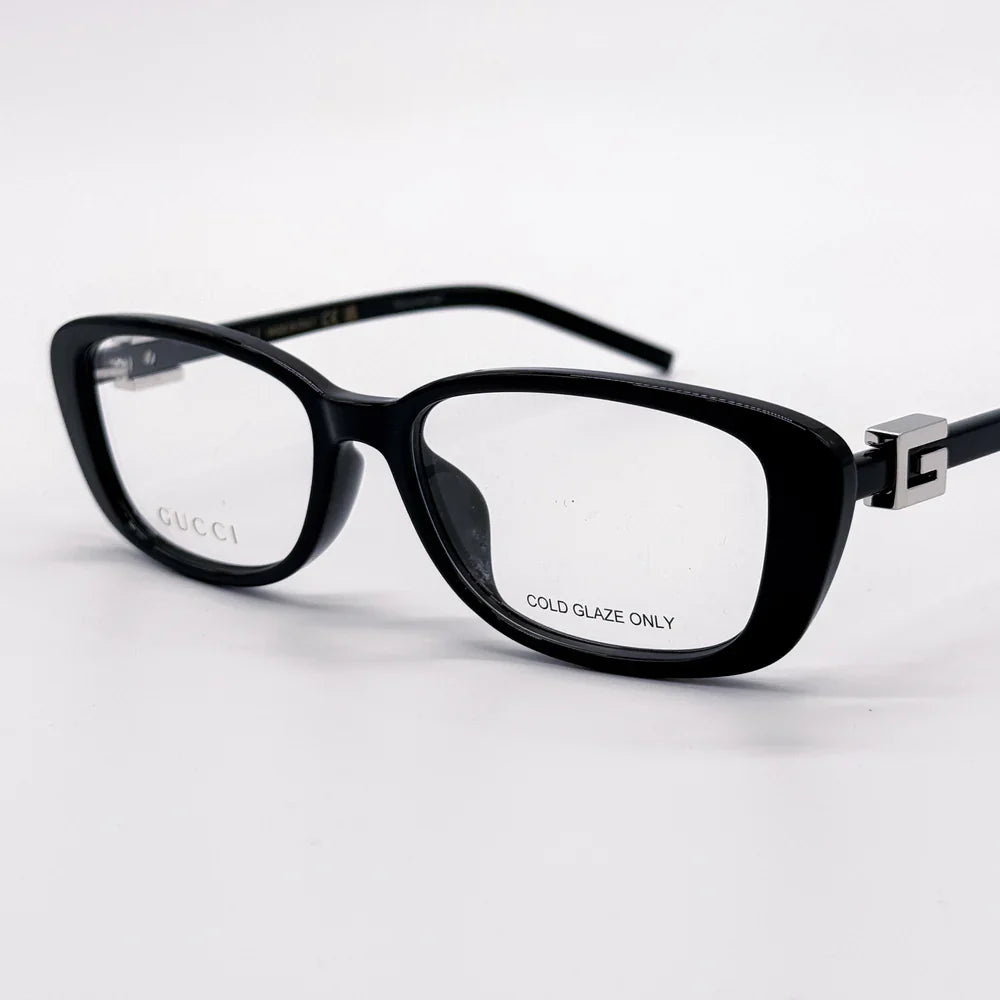 Black Gucci rectangular prescription eyeglasses with clear lenses on a white background.