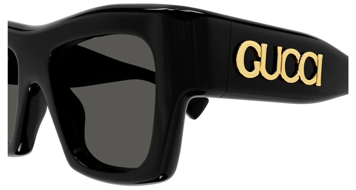 Black luxury sunglasses with gold Gucci logo on the temple