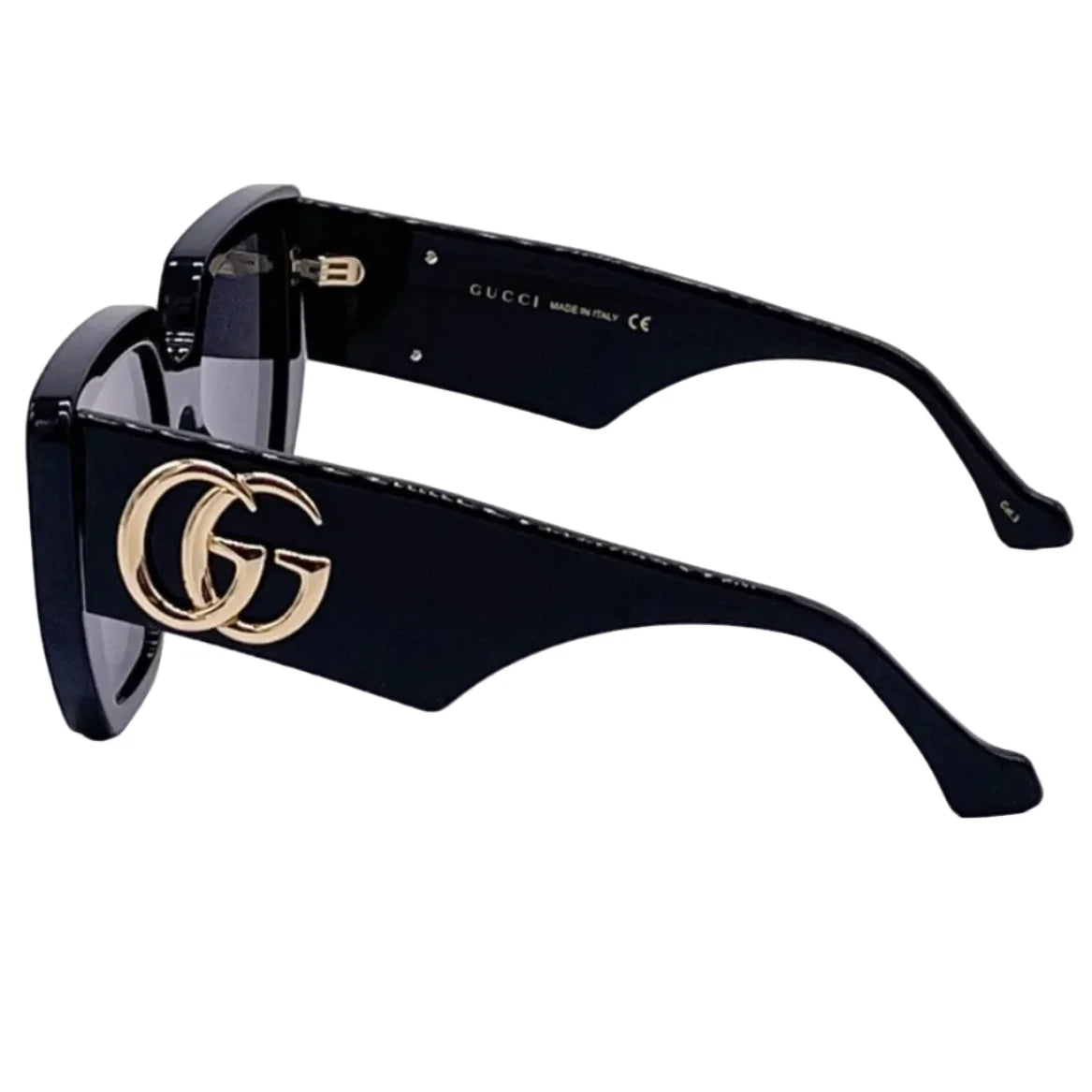 Side view of black luxury Gucci sunglasses with gold interlocking G logo on the temple.